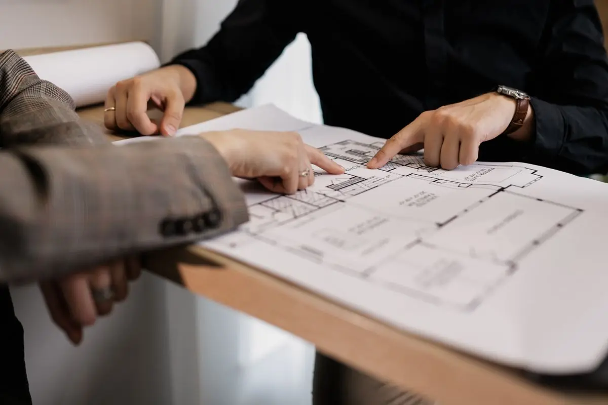 Two team members reviewing a floor plan